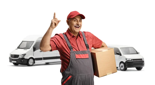 Mature Delivery Man Front Vans Holding Cardboard Box Pointing Isolated — Stock Photo, Image
