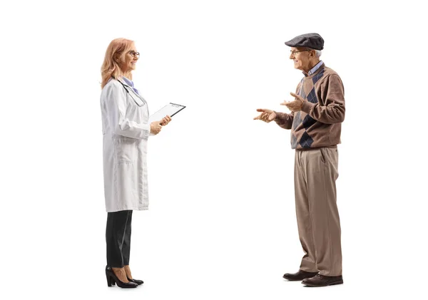 白人の背景に隔離された女性医師と話す高齢患者の完全な長さのプロフィールショット — ストック写真