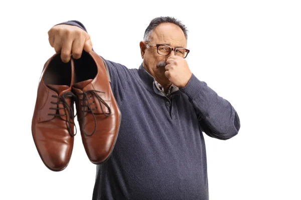 Mature Man Holding Pair Stinky Shoes Isolated White Background — Stock Photo, Image