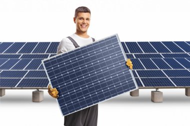 Technician holding a solar panel and smiling at a solar farm isolated on white background clipart