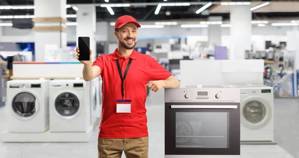 Male Shop Assistant Oven Smiling Showing Smartphone Store — Stock Photo, Image