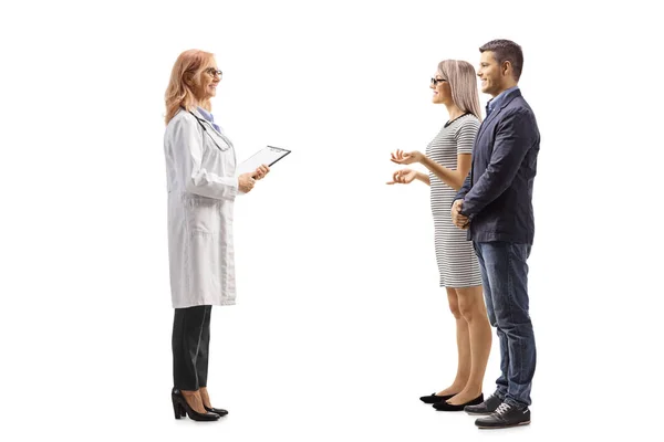 Full Length Profile Shot Young Couple Standing Talking Female Doctor — Stock Photo, Image