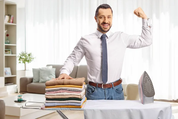 Young Man Iron Pile Clothes Showing Arm Muscles Living Room — Stock Photo, Image