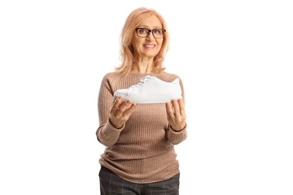 Smiling Mature Woman Holding White Sneaker Isolated White Background — Stock Photo, Image