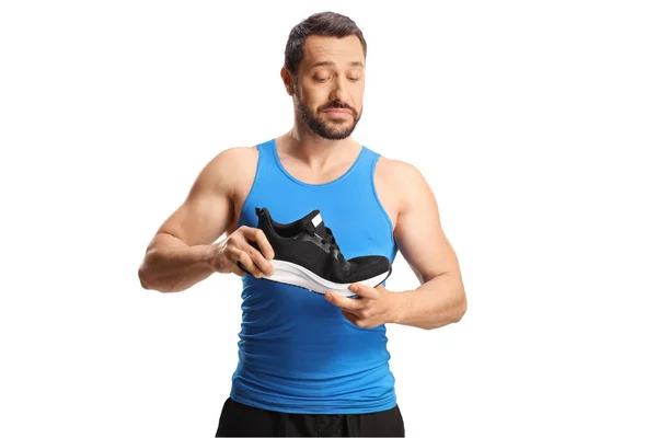 Adatto Giovane Uomo Che Controlla Flessibilità Una Sneaker Corsa Isolata — Foto Stock