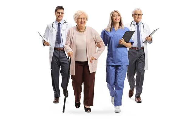 Full Length Portrait Young Female Nurse Male Doctors Walking Elderly — Stock Photo, Image