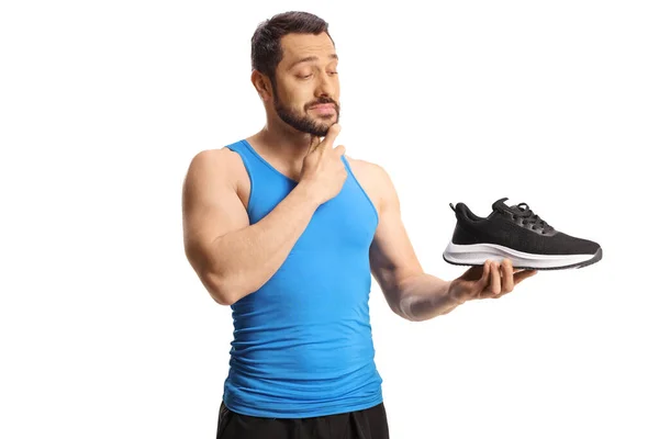 Man Atleet Het Houden Van Een Sneaker Denken Geïsoleerd Witte — Stockfoto