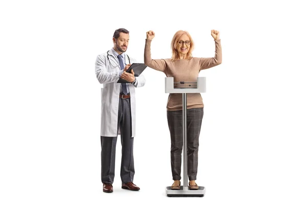 Woman Weighing Scale Gesturing Happiness Male Doctor Writing Document Isolated — Stock Photo, Image