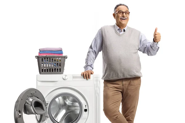 Mature Man Leaning Washing Machine Folded Clothes Showing Thumbs Isolated — Stock Photo, Image