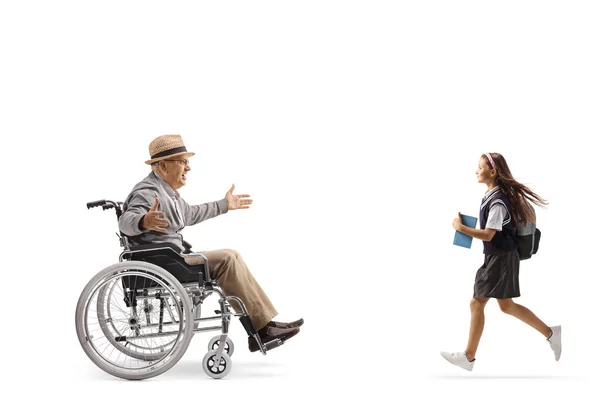 Školačka Knihou Běží Směrem Staršímu Muži Invalidním Vozíku Izolované Bílém — Stock fotografie