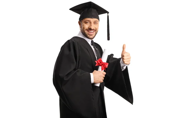 Happy Male Student Wearing Graduation Gown Holding Diploma Gesturing Thumbs — Stock Photo, Image