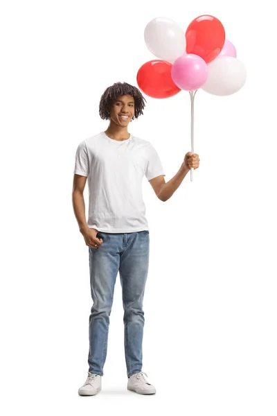 一个非洲裔美国人的全长肖像 面带微笑 手里拿着一堆白色背景的气球 — 图库照片