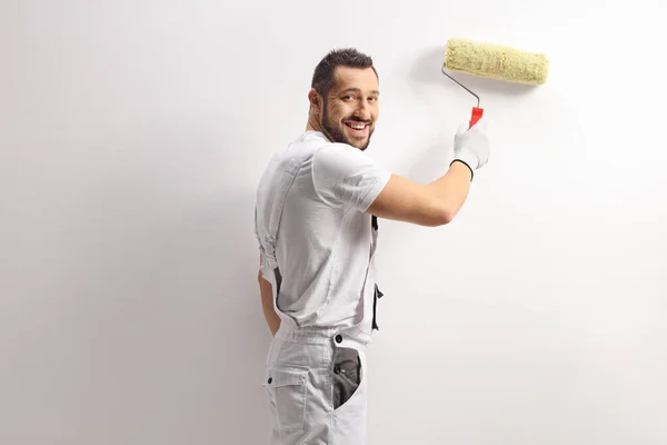 Cheeful House Painter Using Paint Roller Painting Wall — Stock fotografie