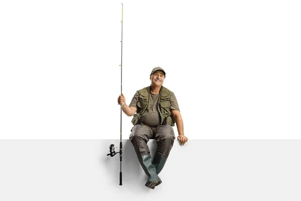 Pescador Maduro Con Caña Pescar Sentado Sobre Panel Blanco Aislado —  Fotos de Stock