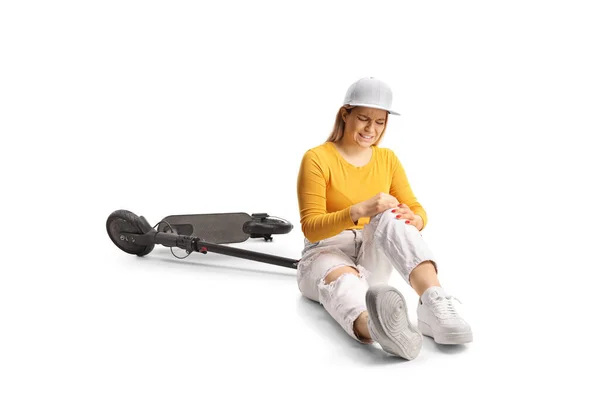 Young Female Scooter Sitting Floor Holding Her Painful Knee Isolated — Stock Photo, Image
