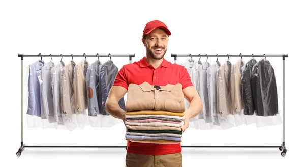 Male Worker Holding Pile Folded Clothes Front Clothing Racks Isolated — Stock Photo, Image