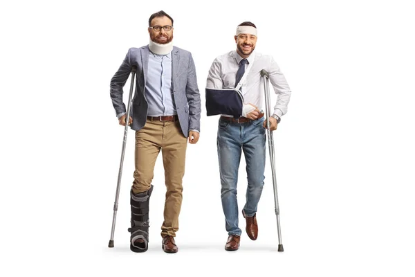 Two Young Injured Men Standing Crutches Isolated White Background — Stock Photo, Image