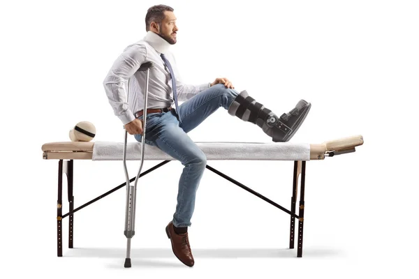 Profile Shot Injured Man Orthopedic Boot Arm Sling Sitting Therapy — Stock Photo, Image