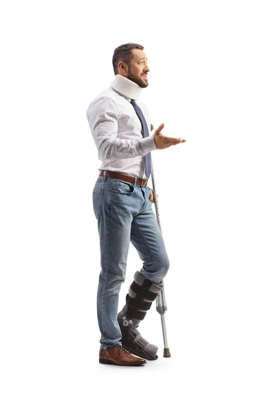 Young Man Orthopedic Boot Cervical Collar Standing Crutch Talking Isolated — Stock Photo, Image
