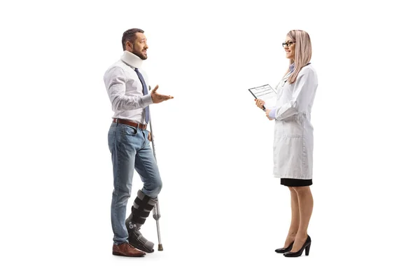 Injured Man Orthopedic Boot Cervical Collar Talking Female Doctor Isolated — Stock Photo, Image
