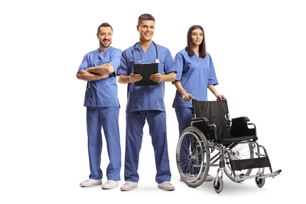 Medical Workers Blue Uniforms Standing Wheelchair Isolated White Background — Stock Photo, Image