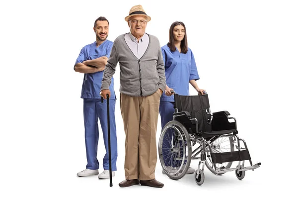 Elderly Man Medical Workers Blue Uniforms Standing Wheelchair Isolated White — Stock Photo, Image