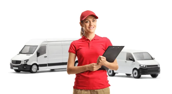 Female Delivery Worker Holding Clipboard Front Transport Vans Isolated White — Stock Photo, Image