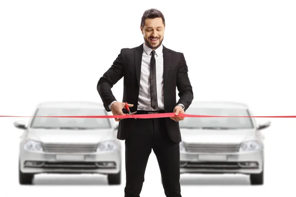 Businessman Cutting Red Ribbon Tape Front Row Silver Cars Isolated — Stock Photo, Image
