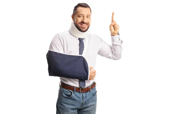 Young Injured Man Cervical Collar Arm Sling Pointing Isolated White — Stock Photo, Image