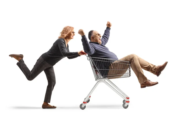 Woman Pushing Excited Mature Man Shopping Cart Isolated White Background — Stock Photo, Image