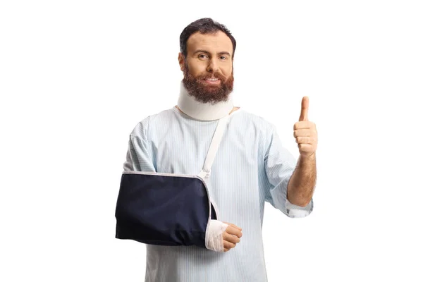 Bearded Male Patient Arm Sling Cervical Collar Gesturing Thumbs Isolated — Stock Photo, Image