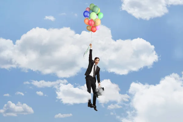 Adamı Elinde Balonlarla Gökyüzünde Uçuyor — Stok fotoğraf