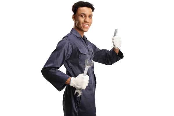 非洲裔美国人汽车修理工手握扳手 在白色的背带上给大姆指做手势 — 图库照片