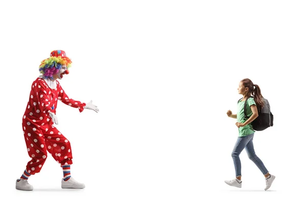 一个背着背包跑向一个被白色背带隔离的小丑的女孩 — 图库照片