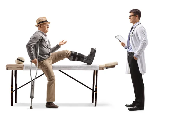 Senior Man Leg Brace Sitting Bed Physical Therapy Talking Doctor — Stock Photo, Image