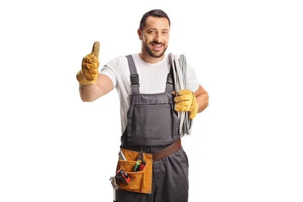 Electrician Holding Cable His Shoulder Gesturing Thumbs Isolated White Background — Stock Photo, Image