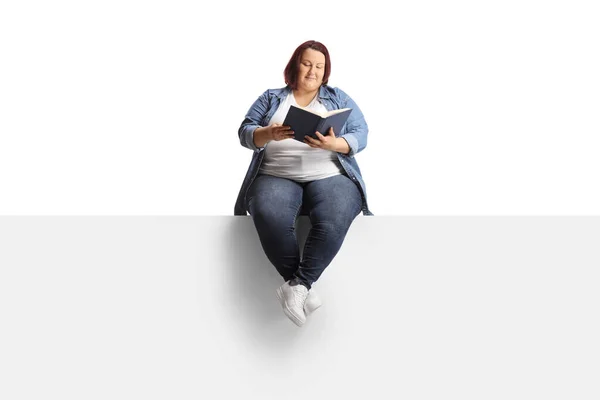 Young Corpulent Woman Sitting Blank Panel Reading Book Isolated White — Stock Photo, Image
