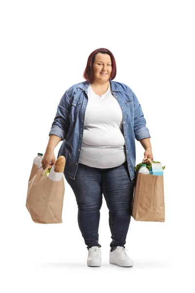 超重的年轻女子背着白色背景的购物袋 — 图库照片