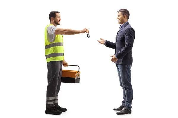 Road Assistance Agent Giving Car Keys Man Isolated White Background — Stock Photo, Image