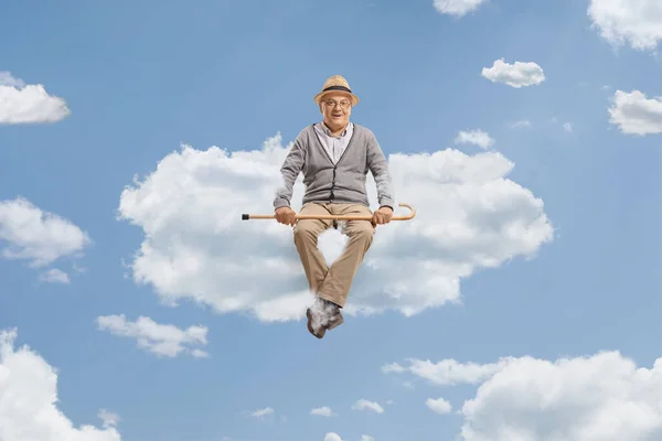 Pensioner Sitting Cloud Holding Walking Cane Sky — Stock Photo, Image