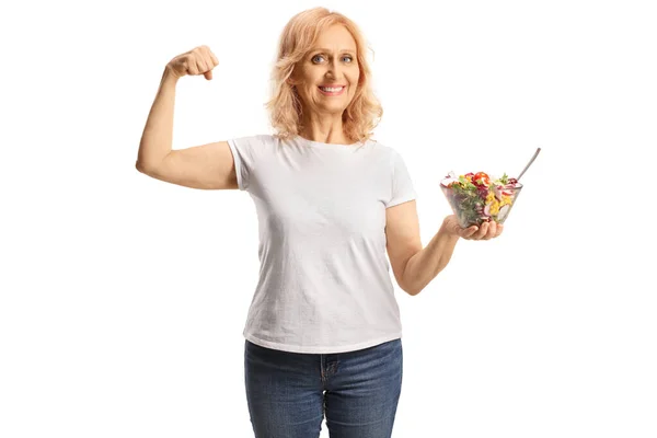 Rijpere Vrouw Met Een Salade Het Tonen Van Sterke Spier — Stockfoto