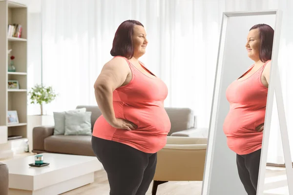 Übergewichtige Frau Sportkleidung Steht Hause Wohnzimmer Vor Dem Spiegel — Stockfoto