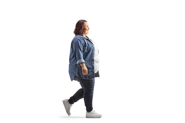 フル長さプロファイルショットのA太りすぎ若いです女性でカジュアル服歩行隔離された白い背景 — ストック写真