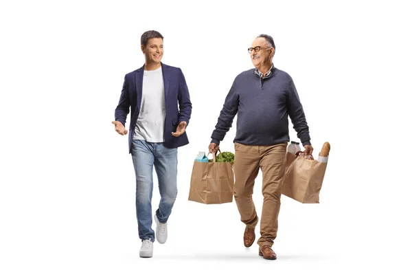 Mature Man Grocery Bags Walking Talking Younger Man Isolated White — Stock Photo, Image