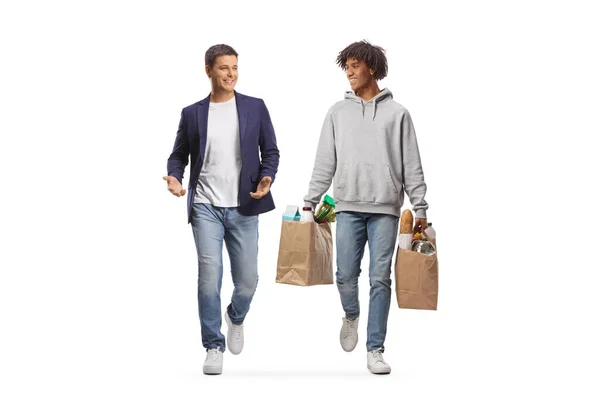 食料品袋を持つアフリカ系アメリカ人の男歩くと白の背景に隔離された友人と話す — ストック写真