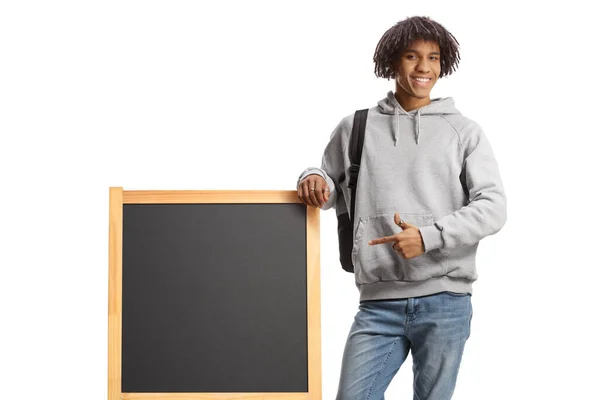 stock image African american male student leaning on a blackboard and pointing isolated on white backgroun