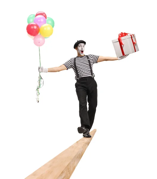 Cheerful Mime Walking Wooden Beam Carrying Balloons Gift Box Isolated — Stock Photo, Image