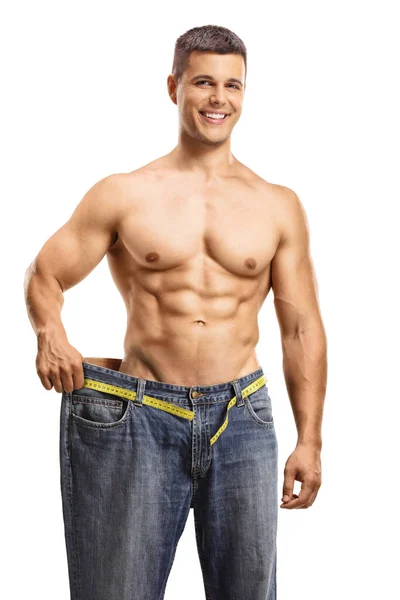 Sorridente Giovane Uomo Cercando Grande Paio Jeans Isolati Backgroun Bianco — Foto Stock