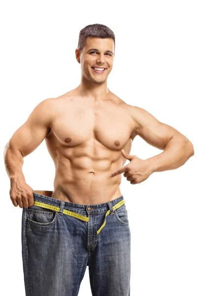 Fit Young Man Trying Big Pair Jeans Pointing His Waist — Stock Photo, Image