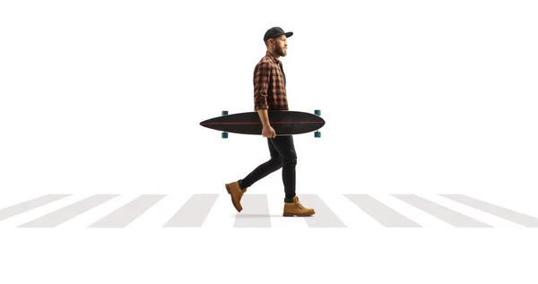 Full Length Profile Shot Guy Carrying Longboard Walking Pedestrian Crosswalk — Zdjęcie stockowe